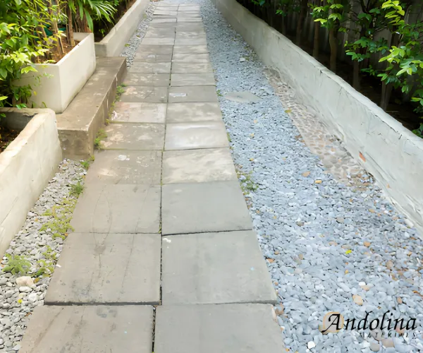 Walkway lined with light gray landscaping stone.