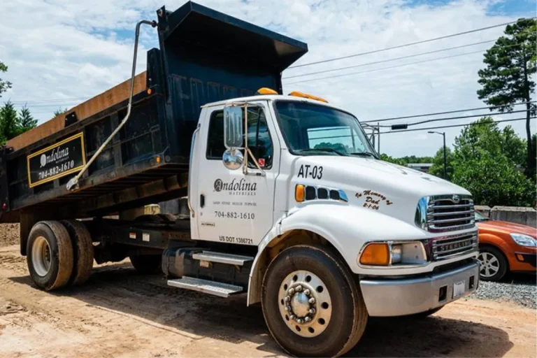 Landscape supply truck delivering bulk materials.